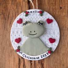 Load image into Gallery viewer, Decorative ornament with a baby's face and 'Amelia' on a wooden surface