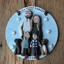 Load image into Gallery viewer, Personalized family ornament with two adults, two children, and two dogs on a wooden background.
