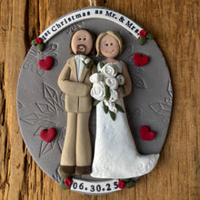 Load image into Gallery viewer, Decorative ornament with a couple, hearts, and text on a wooden background
