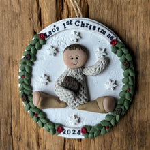 Load image into Gallery viewer, Decorative Christmas ornament with a baby design on a wooden surface
