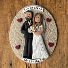 Load image into Gallery viewer, Decorative ornament with a couple in wedding attire on a wooden background
