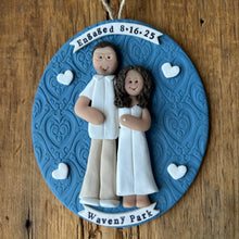 Load image into Gallery viewer, Decorative ornament with a couple holding hands on a blue background, featuring text and heart shapes.
